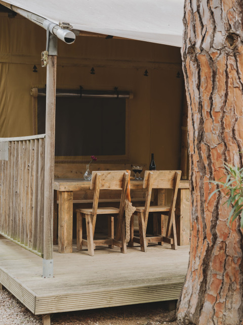 Houten terras met tafel en stoelen bij Lodge Duplex Plus Montgrí, Wecamp L'Escala Punta Mila, Spanje.