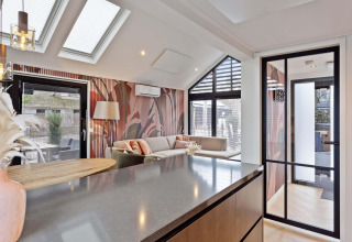 Interior moderno de lodge en Résidence Lage Vuursche con tragaluces, puertas de vidrio y decoración elegante.
