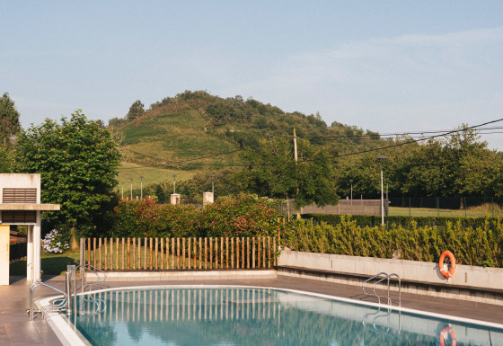 Piscina exterior en Wecamp San Sebastián, parque vacacional con vistas a las colinas en el País Vasco, España.