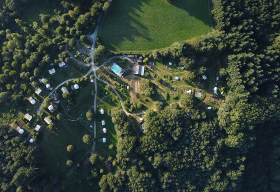 Aerial view of Junora campsite holiday park in Nouvelle-Aquitaine, France, surrounded by lush trees.