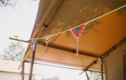 Crocheted bunting under the canopy of the Luxury and spacious Eco-lodge at Campsite Junora, France.