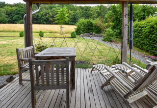 Wooden patio with outdoor furniture overlooking the garden at Holiday home Magma 2 Persons in Germany.