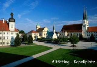 Gezicht op Kapellplatz in Altötting, Duitsland, met kerken en historische gebouwen bij zonnig weer.