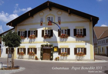 Birthplace of Pope Benedict XVI in Marktl am Inn, Germany, a traditional alpine house with flowers.