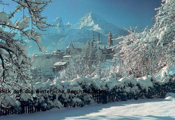 Winter view from the Almhütte chalet in Berchtesgaden, Germany, showing snowy mountains and village.