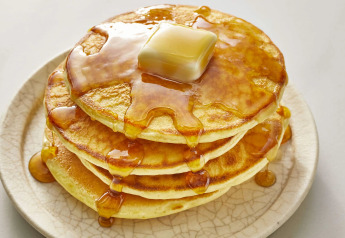 A stack of pancakes with butter and syrup on a plate at the Almhütte chalet in Germany.