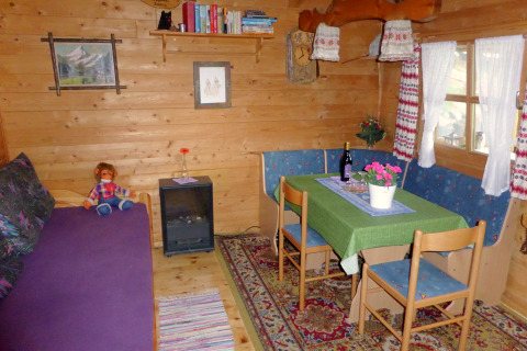 Cozy living area in Chalet Steingaden, Germany, featuring wood paneling, dining table, and country decor.
