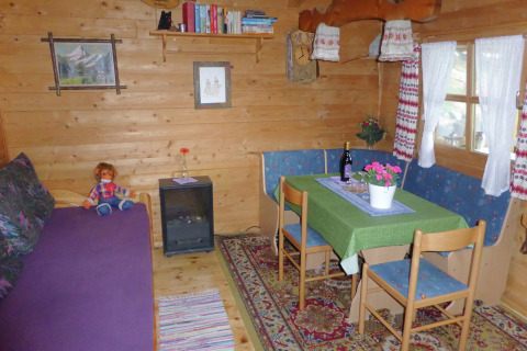Cozy living area in Chalet Steingaden, Germany, featuring wood paneling, dining table, and country decor.