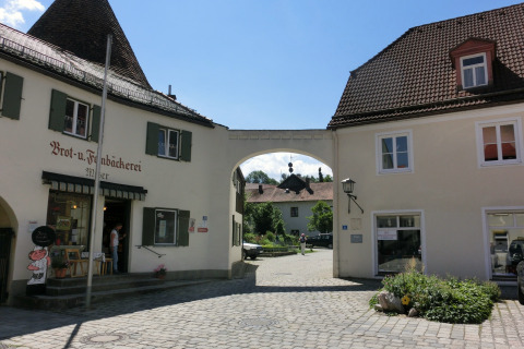 Photo of Steingaden chalet in Germany featuring a bakery, cobblestone street, and traditional buildings.
