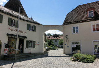 Photo of Steingaden chalet in Germany featuring a bakery, cobblestone street, and traditional buildings.