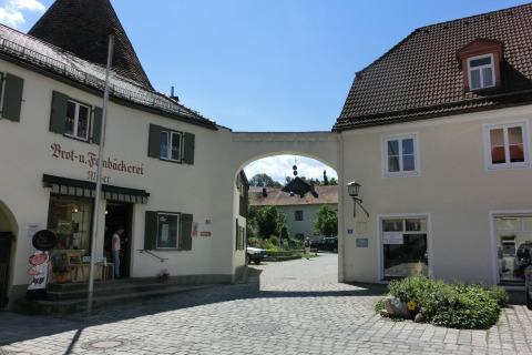 Photo of Steingaden chalet in Germany featuring a bakery, cobblestone street, and traditional buildings.