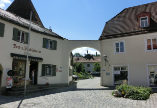 Photo of Steingaden chalet in Germany featuring a bakery, cobblestone street, and traditional buildings.
