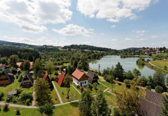 Holiday park Jägerwiesen 1 in Germany with lakeside cottages, lush greenery, and a picturesque landscape.
