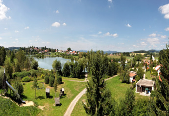 Panoramic view of the lake, Holiday park Jägerwiesen 1 and green landscape in Germany on a sunny day.