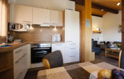 Modern kitchen and dining area in a Holiday village Öfingen chalet in Germany, with cozy and bright interior.