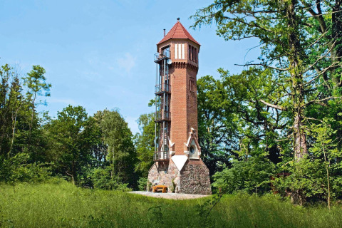Charming chalet named 'Water tower 75 sqm,' tower-shaped and surrounded by trees in Germany.