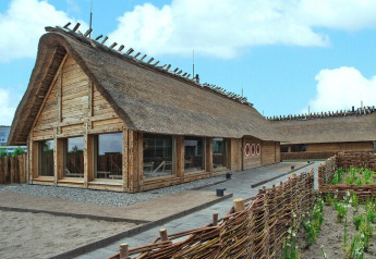Photo of Blockhouse ‘Regular rate 4 Pers’ in Germany, featuring a thatched log structure with rustic fencing.