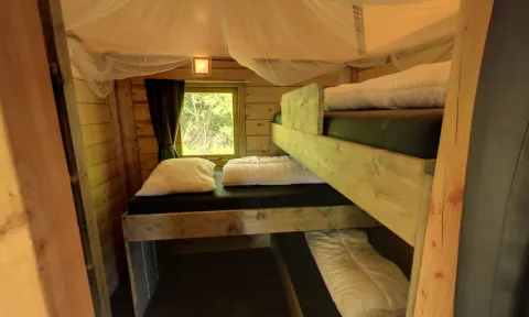 Cozy camper lodge tiny house bunk beds at Family holiday park Krieghuusbelten, Netherlands.