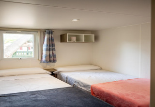 Værelse i Torre del Sol Cottage mobilhome i Spanien, med tre enkeltsenge, vindue og minimalistisk indretning.