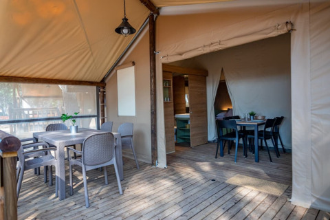 Outdoor and indoor dining areas in a luxury safari tent, Torre del Sol TIENDA SAVANNAH, Spain.