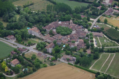 Aerial photo of the picturesque French village near Ecolodge «en Sequoia», surrounded by green fields.