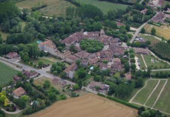 Aerial photo of the picturesque French village near Ecolodge «en Sequoia», surrounded by green fields.