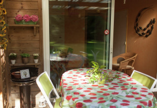 Terraza de Maison de vacances - LE PONCHEL en Francia con mesa, sillas y decoración con plantas.