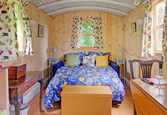 Accogliente casa mobile Higher House nel Regno Unito, con tende animalier e letto colorato.