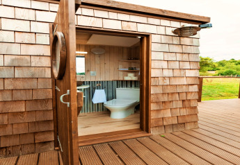 Luxe badkamer in Scotney Luxury Dome, Verenigd Koninkrijk, met houten details en uitzicht op natuur.