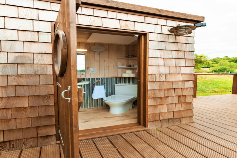 Luxury bathroom at Scotney Luxury Dome in the UK featuring wooden decor and a beautiful countryside view.