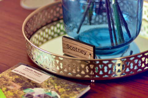 Close-up of 'Scotney' name tag and blue vase on a tray at Scotney Luxury Dome in the United Kingdom.