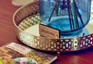 Close-up of 'Scotney' name tag and blue vase on a tray at Scotney Luxury Dome in the United Kingdom.