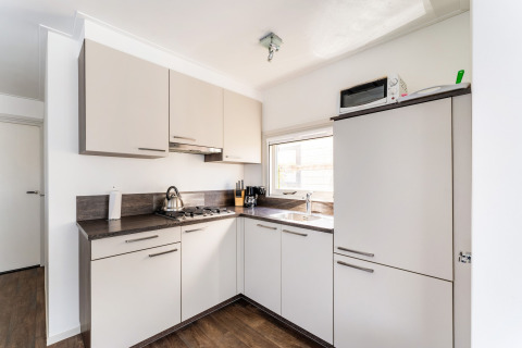 Moderne, lichte keuken op de Luxury chalet 55 woonboot in Nederland, met eigentijds interieur.