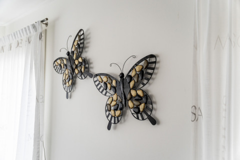 Wall art featuring two butterflies made of metal and stones at Luxury chalet 55 houseboat in the Netherlands.