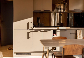 Modern kitchen and dining area at Holiday home in Haarle near Sallandse Heuvelrug in the Netherlands.