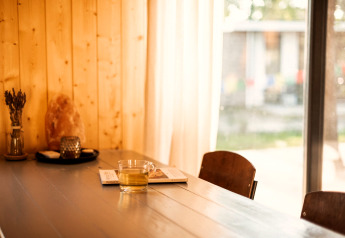 Bright lodge interior at Holiday home in Haarle near Sallandse Heuvelrug, Netherlands, with tea and books.