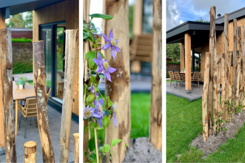 Postes de madera y flores moradas junto a la veranda del Pleasant chalet con exterior en Países Bajos.