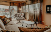 Bright, modern living room aboard Waterpark de Meerparel 5 houseboat in the Netherlands with stylish decor.