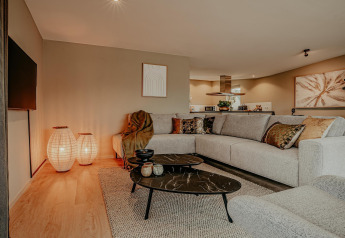 Cozy living room on houseboat Waterpark de Meerparel 5 in the Netherlands with modern sofa and decor.