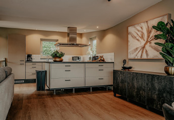 Modern kitchen and living area on the houseboat Waterpark de Meerparel 5, stylishly decorated in the Netherlands.