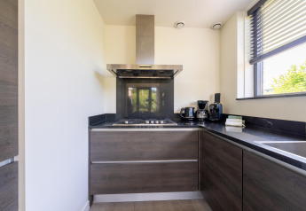 Modern kitchen in the Holiday home Waterland for six Person in the Netherlands, with corner window view.