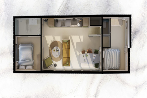 Vista aérea de una casa de playa con dos dormitorios, cocina, baño y una sala de estar interior.
