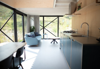 Cocina y sala modernas y luminosas en Sea Lodges Zandvoort 9, Países Bajos, con vista a las dunas.