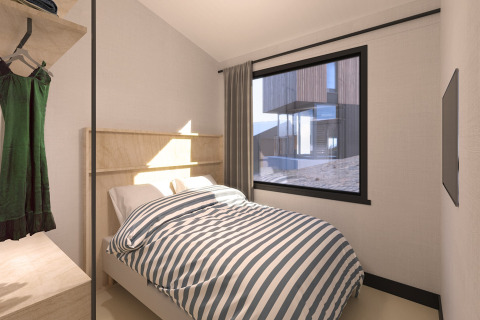 Bedroom with striped bedding and large window in Sea Lodges ‘Zandvoort 11’, beach house in the Netherlands.