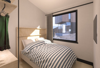 Bedroom with striped bedding and large window in Sea Lodges ‘Zandvoort 11’, beach house in the Netherlands.