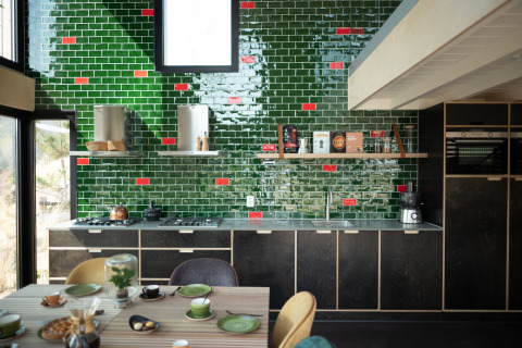 Modern kitchen with green and red tiles at Sea Lodges Zandvoort 11 beach house in the Netherlands.
