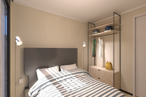 Modern bedroom at Sea Lodges Zandvoort 11 in the Netherlands with a double bed and open wardrobe.