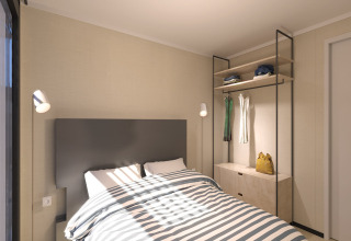 Modern bedroom at Sea Lodges Zandvoort 11 in the Netherlands with a double bed and open wardrobe.