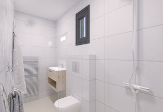 Modern white-tiled bathroom with window, towel heater, and shower at Sea Lodges Zandvoort 11, Netherlands.