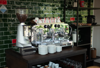 Espresso machine and coffee cups on counter at Sea Lodges Zandvoort 11 beach house in the Netherlands.
